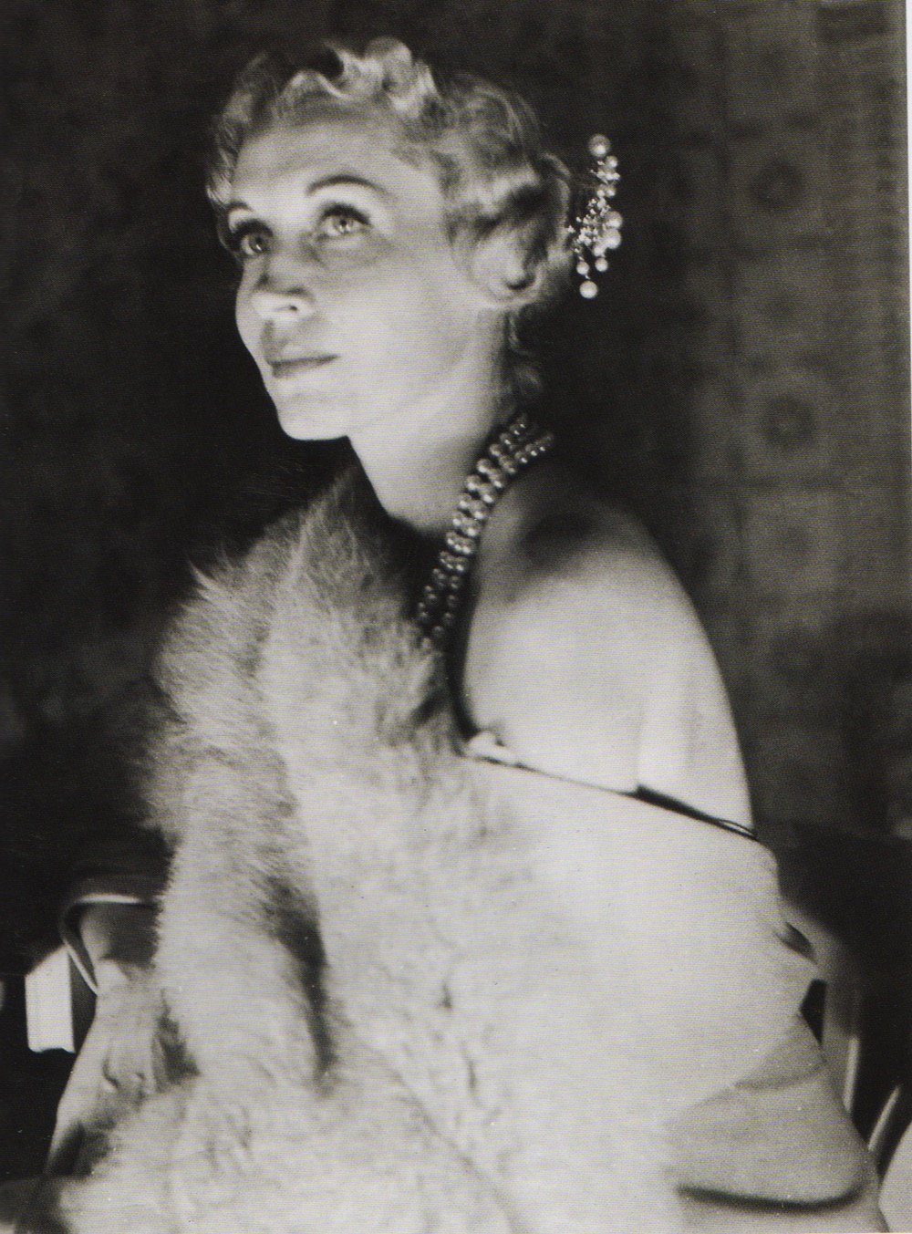 Elegance in 1930s fashion - Diamond dress clips (on fur) and diamond earrings.