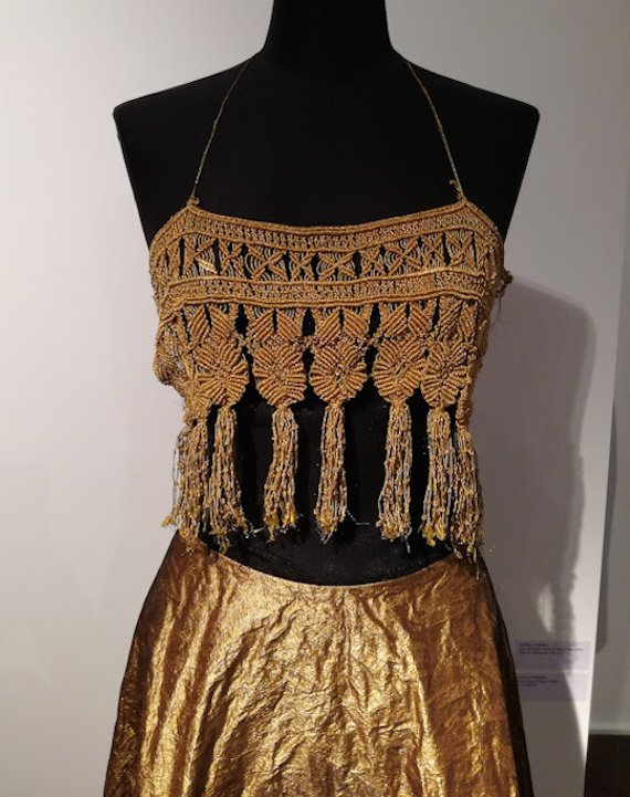 Detail of gold outfit. Detail of gold outfit.
