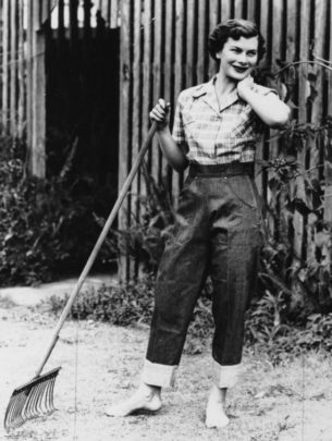 high waisted fashion.Young woman modelling denim jeans and checked shirt, 1952