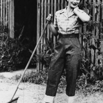 high waisted fashion.Young woman modelling denim jeans and checked shirt, 1952