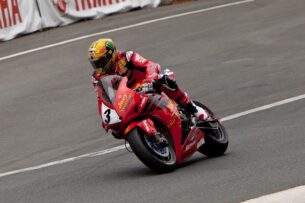 What are the best motorcycle jacket brands - John McGuinness riding at the Dainese Superbike TT 2013.