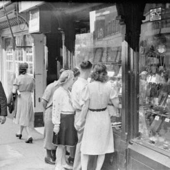 40s Ladies Fashion-Young men and women look in the window of a jeweller's shop on Silver Street in Durham, England, UK, 1943