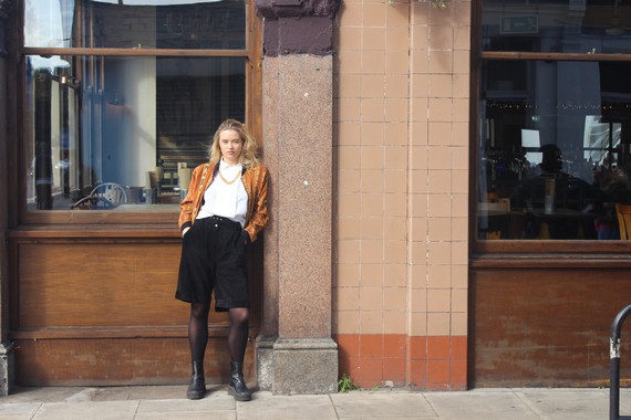 90s knee length shorts, black tights , black stomper boots, white shirt and orange striped bomber jacket. 90s knee length shorts, black tights , black stomper boots, white shirt and orange striped bomber jacket.