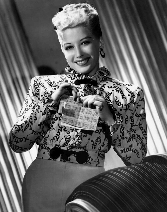 1945 Photo of singer Helen Forrest, wearing a World War II blouse with the word "ration" printed on it and she is holding a ration book. 1945 Photo of singer Helen Forrest, wearing a World War II blouse with the word "ration" printed on it and she is holding a ration book.