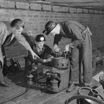 Vintage workwear uk, photo of Men working in British army training school, Sheffield, 1944 photo