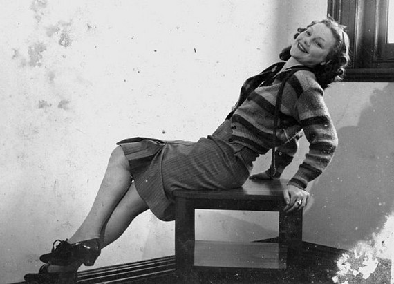 Young Woman wearing knee length skirt and striped cardigan, 1940s Young Woman wearing knee length skirt and striped cardigan, 1940s