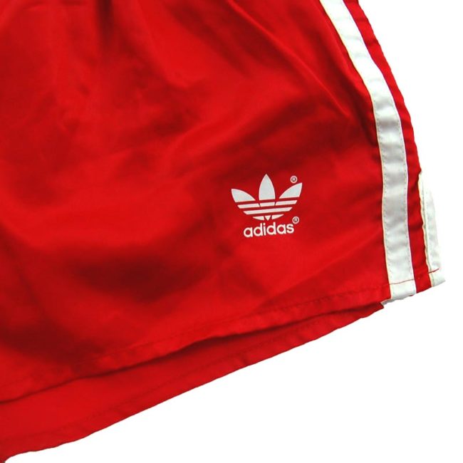 front of 90s Red Adidas Shorts
