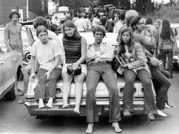 Photo of festival goers riding on boot of a car, near the Woodstock music festival on August 18, 1969 Photo of festival goers riding on boot of a car, near the Woodstock music festival on August 18, 1969