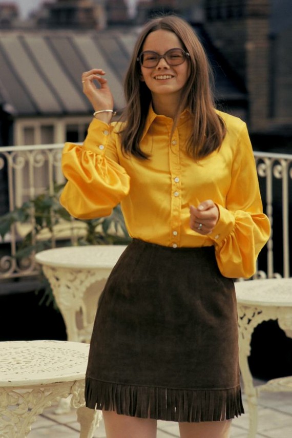 Girl wears yellow shirt and fringed suede mini skirt on Kensington roof terrace in 1971 Girl wears yellow shirt and fringed suede mini skirt on Kensington roof terrace in 1971