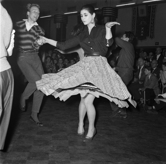 Guy with girl wearing wide circle skirt and 50s blouse, dancing at Rock-'n-Roll dance, 1957 Guy with girl wearing wide circle skirt and 50s blouse, dancing at Rock-'n-Roll dance, 1957