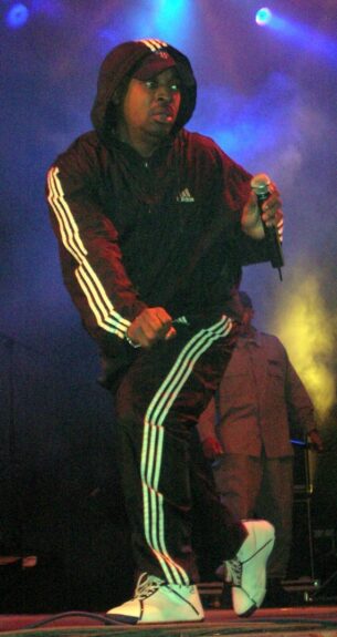 Chuck D in Adidas shell suit top and Adidas shell suit bottoms