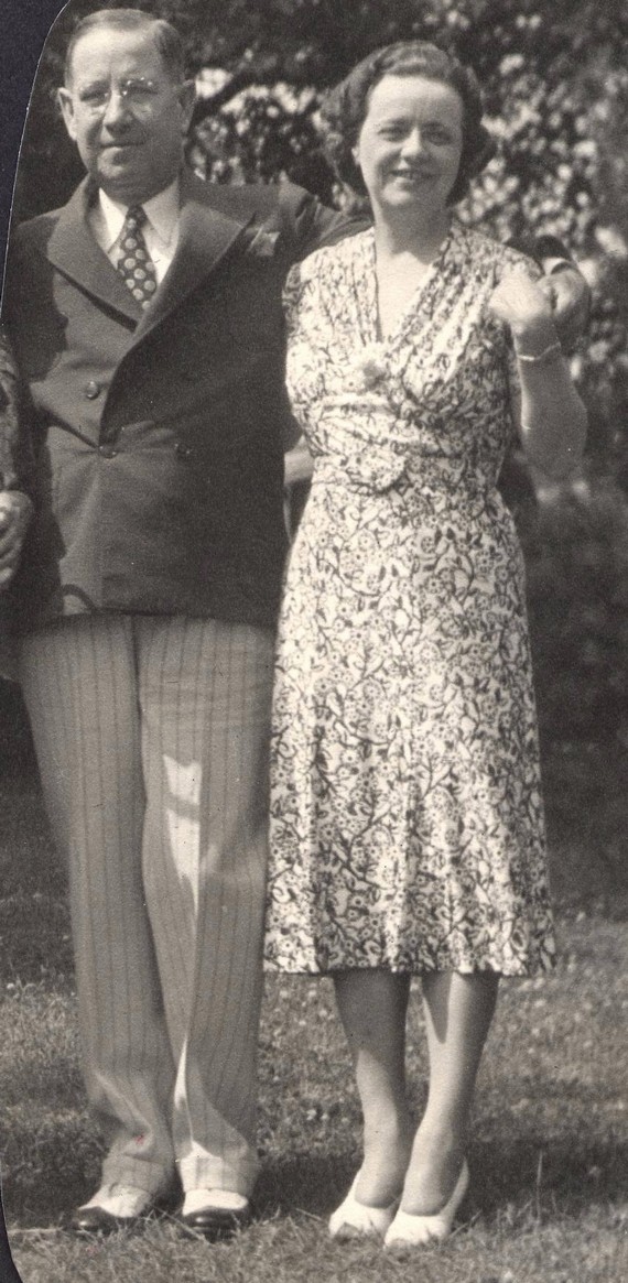 Woman wearing a tea dress standing next to her husband, 1938 Woman wearing a tea dress standing next to her husband, 1938