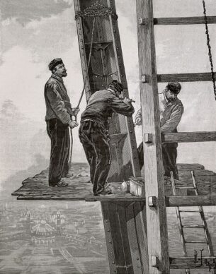 French chore jackets with construction workers standing on an elevated platform on the Eiffel Tower, 1889