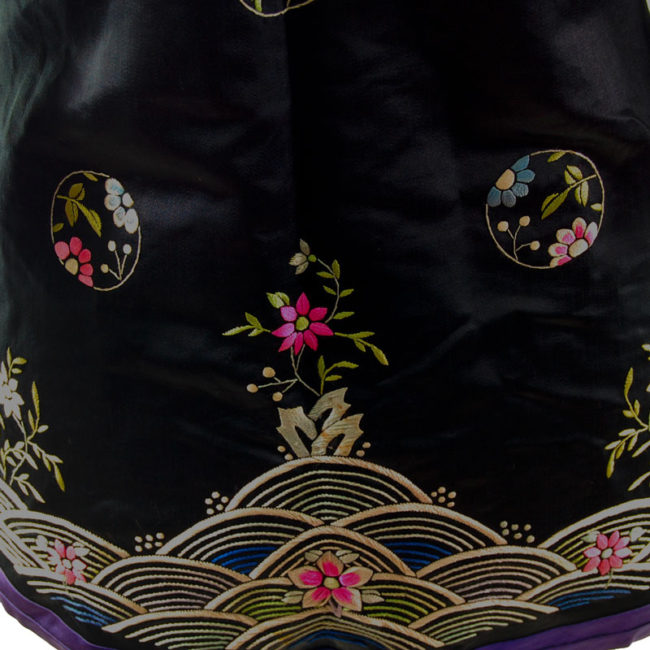 Traditional Hanfu Robe pattern Features a black block colour shirt with embroidered flowers and hills on the hemline with embroidered flowers.