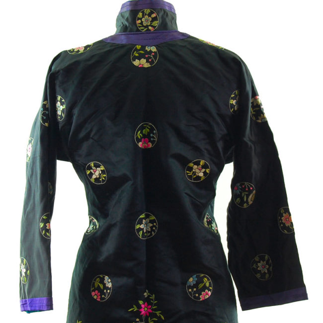 close back Features a black block colour shirt with embroidered flowers and hills on the hemline with embroidered flowers.