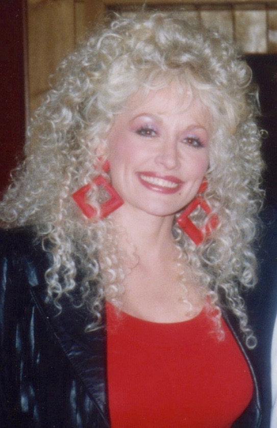 Dolly Parton wearing square red earrings at a recording session ,1989 Dolly Parton wearing square red earrings at a recording session ,1989