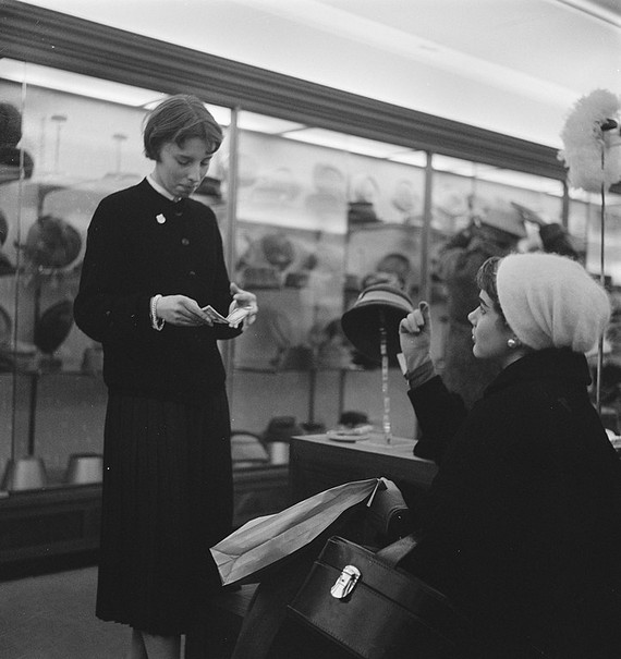 Woman shopping for hats in millinary department, 1957 Woman shopping for hats in millinary department, 1957