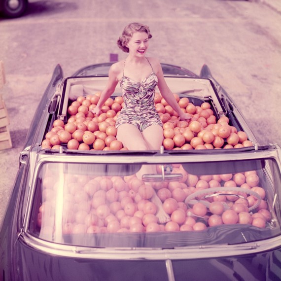 Douglas Jones photograph of a Woman in swimsuit in a car full of oranges, 1951 Douglas Jones photograph of a Woman in swimsuit in a car full of oranges, 1951