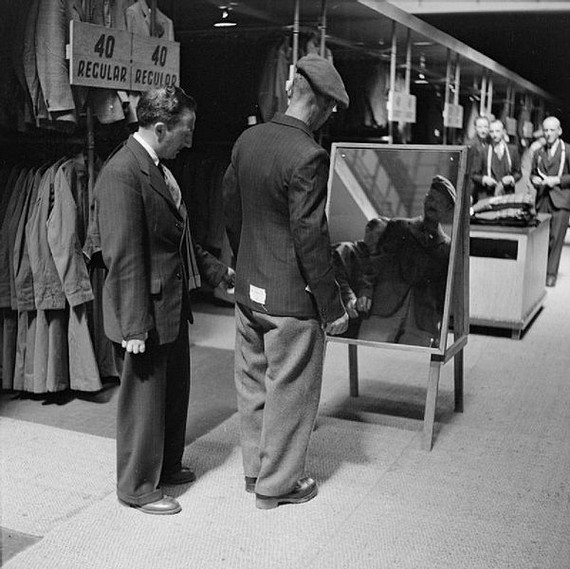 Private Bill Krepper, Pioneer Corps tries his demob suit in front of a standing morror with a civilian tailor at the demobilisation clothing depot, Olympia, London, photo shot estimated timedate between 1939 and 1945 Private Bill Krepper, Pioneer Corps tries his demob suit in front of a standing morror with a civilian tailor at the demobilisation clothing depot, Olympia, London, photo shot estimated timedate between 1939 and 1945