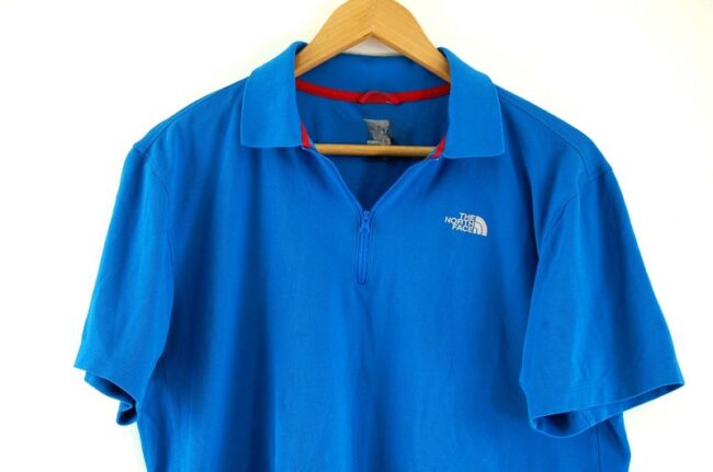 Close up of Blue The North Face Polo Shirt