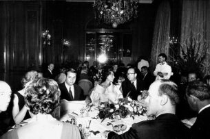 1962 the business of haute couture - Black and white photo of fashion journalist Marie-Jacques Perrier at a dinner for the designer Charles Jourdan, Plaza Athénée hotel in 1962