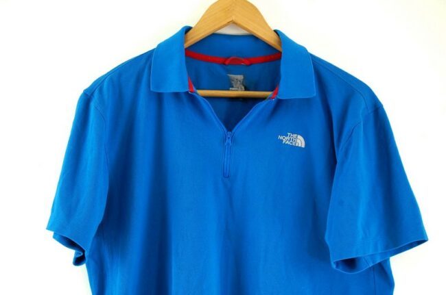Close up of Blue The North Face Polo Shirt