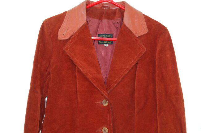 Close up of Rust Coloured Womans 70s suede jacket With Leather Trim