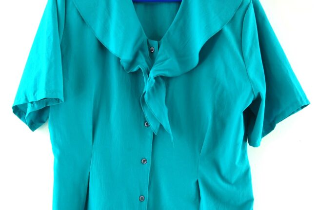 Close up of 90s Turquoise Tie Neck Blouse