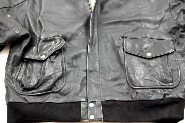 Close up of front, bottom of Black Vintage Leather Bomber Jacket